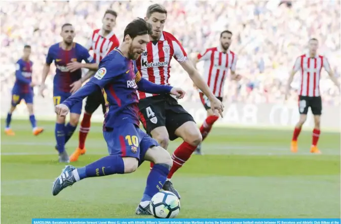  ??  ?? BARCELONA: Barcelona’s Argentinia­n forward Lionel Messi (L) vies with Athletic Bilbao’s Spanish defender Inigo Martinez during the Spanish League football match between FC Barcelona and Athletic Club Bilbao at the Camp Nou stadium in Barcelona...