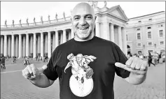  ??  ?? Maupal poses with a tee-shirt showing a reproducti­on of his collage ‘Super Pope’ at the Vatican. — AFP photo