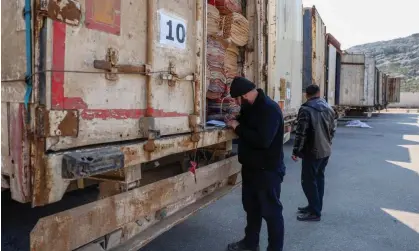  ?? Photograph: Omar Haj Kadour/AFP/Getty Images ?? A clerk inspects the cargo of a truck in a convoy carrying tent and shelter kits at Bab al-Hawa, currently the only route to rebel-held Idlib.