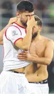  ?? Picture: AFP ?? Syria’s Mohammed Osman is consoled by teammate Mahmoud Al Mawas after the loss to Australia.