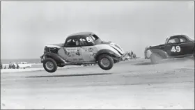 ?? ASSOCIATED PRESS FILE PHOTO ?? Red Farmer (61) goes airborne after hitting a hole on the four-mile Daytona Beach road course during the 1953100-mile Modified and Sportsmen type stock car race in Daytona Beach, Fla.