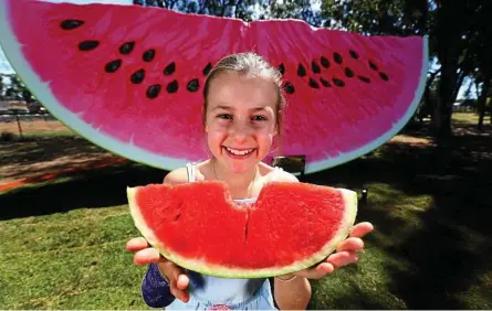  ??  ?? NEW BIG THING: Tilly Hart, 10, from Chinchilla checks out the town’s latest tourist attraction, the Big Melon.