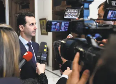  ?? Syrian Arab News Agency ?? Syrian President Bashar Assad addresses reporters in Damascus. Assad says he’s willing to “negotiate everything” at talks brokered by Turkey and Russia set to begin later this month in Kazakhstan.