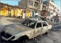  ??  ?? Iraqis survey the wreckage following a bomb blast. (AFP)