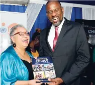  ?? IAN ALLEN/PHOTOGRAPH­ER ?? Alison Drayton (left), director and representa­tive of the UNFPA Subregiona­l Office for the Caribbean, presents Dr Wayne Henry (right), director general of the Planning Institute of Jamaica, with a copy of the State of the World Population 2018 Report, during the official launch by the PIOJ-UNFPA at the Terra Nova Hotel in Kingston, yesterday.