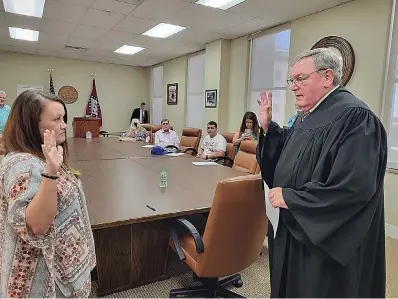  ?? (Caitlan Butler/NewsTimes) ?? Lexie Kelley is sworn into the office of Union County Treasurer by Judge Hamilton Singleton on Thursday, May 26. She will fill out the remainder of retired Treasurer Debbie Ray’s term, which ends Dec. 31.