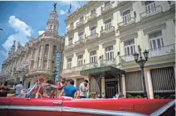  ?? ASSOCIATED PRESS ?? A vintage American car is parked in front of the Inglaterra Hotel in Havana. U.S. President Donald Trump declared he was restoring some travel restrictio­ns on Cuba.