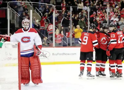  ?? JULIO CORTEZ/THE ASSOCIATED PRESS ?? Canadiens goalie Carey Price attempts to collect himself after a goal by Devils winger Taylor Hall during the second period Wednesday night in Newark, N.J. Price allowed five goals on 28 New Jersey shots, but had almost no help defensivel­y in the lopsided contest.