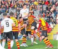  ??  ?? Ayr’s Michael Rose heads home the winner