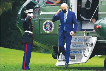  ?? Associated Press ?? President Joe Biden salutes Monday as he steps off of Marine One on the South Lawn of the White House in Washington. He and first lady Jill Biden spent the weekend at their home in Wilmington, Del.