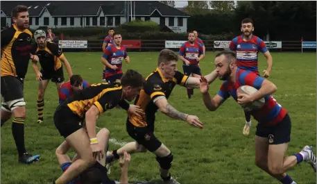  ?? Castleisla­nd’s Conor O’Shea look to clip a couple of Youghal tacklers in their Munster J-League Division 2 game ??