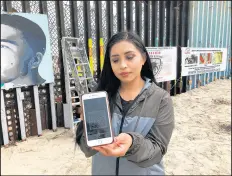  ?? ELLIOT SPAGAT/AP ?? The interactiv­e mural in Tijuana that lets smartphone users hear narratives is the vision of Lizbeth De La Cruz Santana.