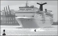  ?? AP/LYNNE SLADKY ?? A jet skier passes in front of the Carnival Sensation cruise ship as it leaves Miami Beach, Fla., on June 20. The cruise operator on Monday announced a profit of $1.4 billion, or $1.93 a share, in the quarter that ended Aug. 31.