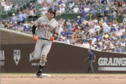  ?? PHOTOS BY MARK BLACK — THE ASSOCIATED PRESS ?? The San Francisco Giants’ Wilmer Flores rounds second during his two-run home run against the Chicago Cubs during the fifth inning Sunday in Chicago.
