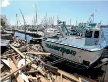  ?? AP ?? Damaged boats and debris clutter the waterfront in Panama City, Florida.