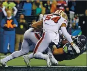  ?? TED S. WARREN — THE ASSOCIATED PRESS ?? Seahawks tight end Jacob Hollister, right, was stopped just short of the goal line by San Fransciso linebacker­s Fred Warner (54) and Dre Greenlaw on the last play of the 2019 regular- season finale that gave the 49ers the NFC’S No. 1 seed in last year’s playoffs.