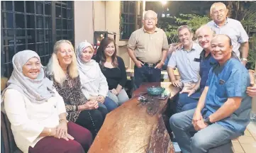  ??  ?? Rahman (standing at left) with Rich (seated second right), Rahman’s wife Datin Sa’adiah Morshidi (left), Rich’s wife Elise (second left) and other guests at the Hari Raya Aidilfitri open house.