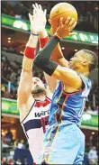  ??  ?? Russell Westbrook #0 of the Oklahoma City Thunder puts up a shot over Marcin Gortat #13 of the Washington Wizards in the first half at Verizon Center on Nov 10, in
Washington, DC. (AFP)