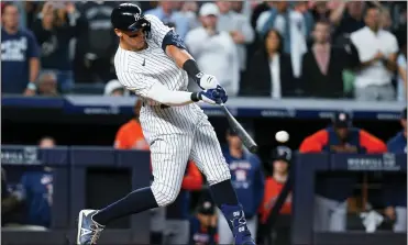  ?? FRANK FRANKLIN II — THE ASSOCIATED PRESS ?? Yankees’ Aaron Judge hits a single to drive in the winning run during the ninth inning of Thursday’s game against the Astros in New York.