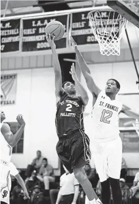  ?? COLBY WARE/ SPECIAL TO THE BALTIMORE SUN ?? Point guard Everette Hammond of St. Vincent Pallotti shoots over Tairik Johnson of St. Frances. Hammond, who scored 15 points in the game, hit the winning 3-pointer.