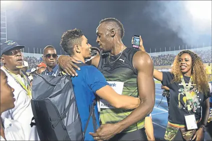  ?? FOTO: AP ?? Bolt, abrazando a Van Niekerk en Kingston en junio. Bolt valora la versatilid­ad del sudafrican­o, el más señalado como probable sucesor