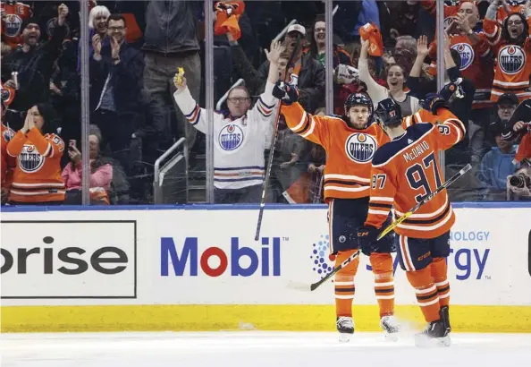  ?? Jason Franson/THE CanaDIan PrEss ?? Oilers stars Leon Draisaitl and Connor McDavid celebrate Draisaitl’s first-period goal against the Dallas Stars on Thursday night at Rogers Place. The Oilers jumped out to a 2-0 lead but lost 3-2 in a shootout.