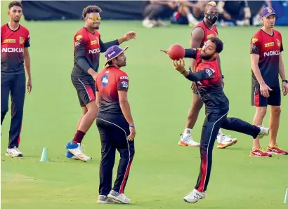  ?? PTI ?? Kolkata Knight Riders players during a practice session ahead of their IPL match against Mumbai Indians. —