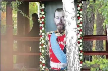  ?? AFP ?? A portrait of the last Russian tsar, Nicholas II, is seen outside Yekaterinb­urg, Russia last year.