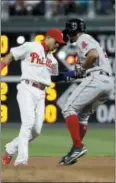  ?? MATT SLOCUM — THE ASSOCIATED PRESS ?? Phillies second baseman Cesar Hernandez, left, tags out Boston’s Xander Bogaerts on a fielder’s choice in the ninth inning Tuesday.