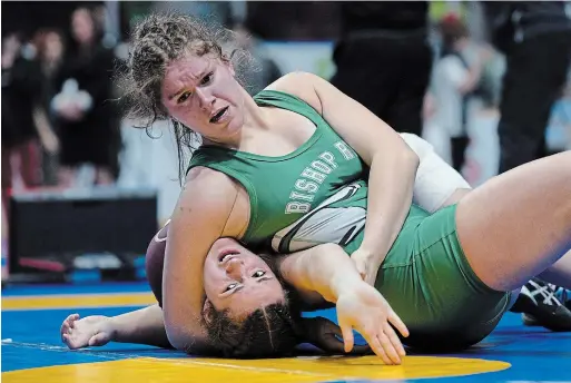  ?? MICHAEL P. HALL ?? Bishop Ryan’s Claudia Landry keeps a tight hold on her opponent at the OFSAA wrestling championsh­ip in Ottawa last weekend. Landry, one of several Hamilton athletes who travelled to the national capital, beat Davyne Buehler of London’s Sir Frederick Banting to earn gold in the girls 83-kilogram mat competitio­n.