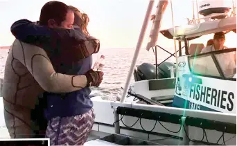  ??  ?? Safe: John Craig hugs his wife Emma, also inset, moments after stepping off the rescue boat