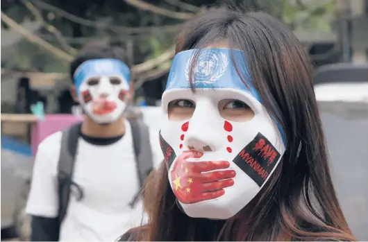  ?? AP ?? Masked demonstrat­ors on April 4 in Yangon, Myanmar. A military takeover on Feb. 1 has resulted in gruesome human rights abuses across the Southeast Asian nation.