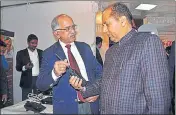  ?? DEEPAK SANSTA/HT ?? Himachal CM Jai Ram Thakur takes a look at a wireless set at the Police Science Congress in Shimla on Thursday.