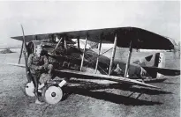  ?? ASSOCIATED PRESS FILE PHOTO ?? American World War I fighter pilot Eddie Rickenback­er poses with his Spad airplane in this undated photo.