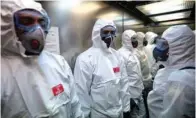  ?? (AFP) ?? Members of the Military Emergencie­s Unit during a general disinfecti­on at the Sant Antoni extended care facility in Barcelona, Spain, on Saturday.