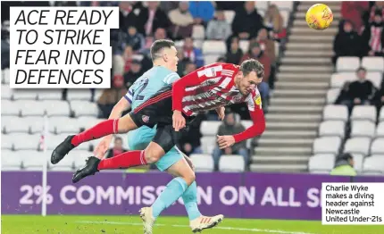  ??  ?? Charlie Wyke makes a diving header against Newcastle United Under-21s