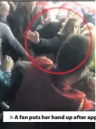  ??  ?? &gt; A fan puts her hand up after apparently being struck on the back of the head at the Wales v Australia game