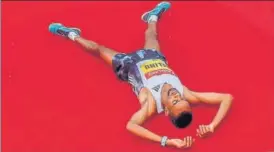  ?? PTI ?? ■
Andamlak Belihu lies on the ground after winning the Delhi Half Marathon on Sunday.