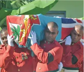  ??  ?? RFMF pall bearers carry the casket of the late Private Josese Ledua.