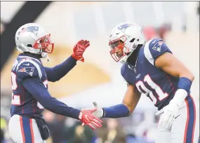  ?? Maddie Meyer / Getty Images ?? Patriots’ Devin McCourty, left, high fives Deatrich Wise Jr. during the first quarter of a game against the Buffalo Bills on Dec. 24.