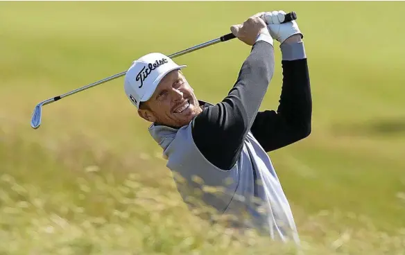  ??  ?? SCOTLAND SWING: Andrew Dodt plays his second shot on the first hole of his final round at the Scottish Open. PHOTO: MARK RUNNACLES/AAP IMAGE