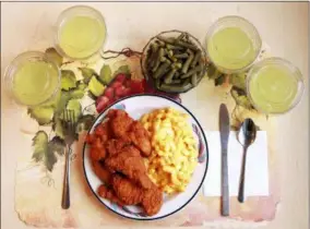  ?? PAULE JOSEPH, SHAVONNE POCOCK — NIH VIA AP ?? This shows an “ultra-processed” lunch including brand name macaroni and cheese, chicken tenders, canned green beans and diet lemonade. Researcher­s found people ate an average of 500 extra calories a day when fed mostly processed foods, compared with when the same people were fed minimally processed foods. That’s even though researcher­s tried to match the meals for nutrients like fat, fiber and sugar.