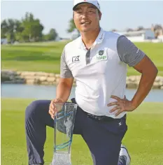  ?? GETTY IMAGES ?? K.H. Lee of South Korea poses with the trophy on the 18th green Sunday after winning the AT&T Byron Nelson tournament at TPC Craig Ranch.