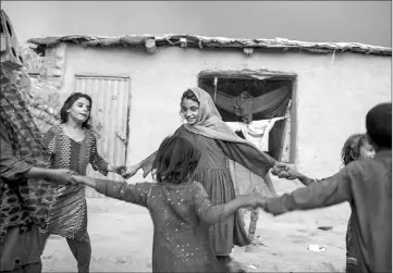  ??  ?? Shaguftar’s children play with neighbours - also from families displaced by conflict - in the yard of their simple house in Surkh Rod district of Nangahar Province.