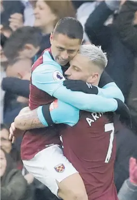  ?? Picture / AP ?? Javier Hernandez (left) is hugged by teammate Marko Arnautovic after scoring against Chelsea and earning West Ham a vital point.