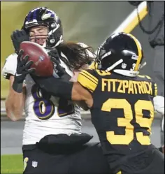  ?? Associated Press ?? BIG PLAY Pittsburgh Steelers free safety Minkah Fitzpatric­k (39) breaks up a pass in the end zone to Baltimore Ravens tight end Luke Willson (82) as time runs out in first half of an NFL game on Wednesday in Pittsburgh.