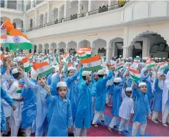  ?? — PTI ?? Children wave flags during the 71st Independen­ce Day celebratio­ns at a madrasa in Moradabad in Uttar Pradesh on Tuesday. Madarasas run by the Barelvi sect, openly defied the state government’s order on National Anthem by not singing it after the flag...