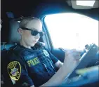  ?? Rachel Rosenbaum/appeal-democrat ?? Marysville Police officer Kathryn Danisan fills out a stolen vehicle report on Aug. 16, 2018.