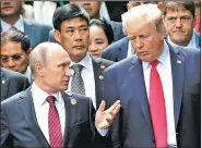  ?? AP/MIKHAIL KLIMENTYEV ?? Presidents Vladimir Putin and Donald Trump talk Saturday during a photo session at the Asian-Pacific Economic Cooperatio­n summit in Danang, Vietnam.