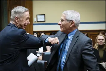  ?? PETE MAROVICH — THE NEW YORK TIMES ?? Rep. Stephen Lynch, D-Mass., left, and Dr. Anthony Fauci, director of the National Institute of Allergy and Infectious Diseases, greet each other with an elbow bump before a House Oversight & Reform Committee hearing on Wednesday.